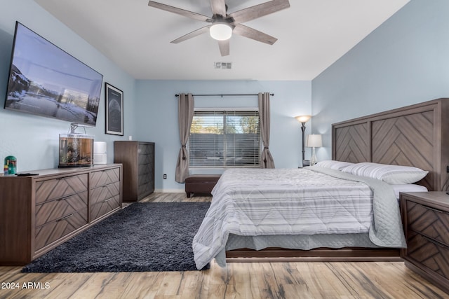 bedroom with ceiling fan and light hardwood / wood-style floors