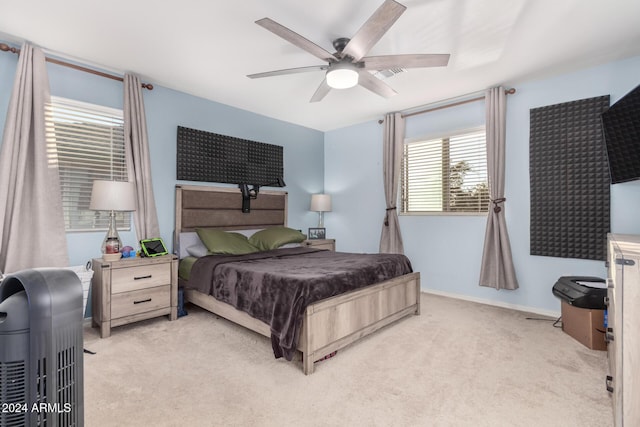 bedroom featuring ceiling fan and light carpet