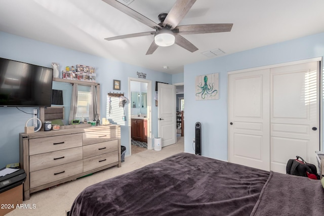 carpeted bedroom featuring multiple windows, connected bathroom, a closet, and ceiling fan