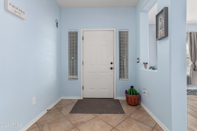 foyer entrance featuring light tile patterned flooring