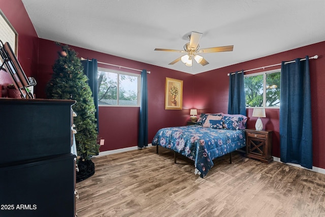 6289 E Duchess Dr, Prescott Valley, AZ 86314 - bedroom with wood finished floors, baseboards, and a ceiling fan