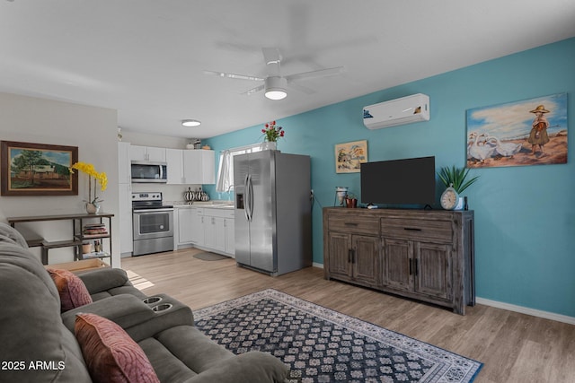 6289 E Duchess Dr, Prescott Valley, AZ 86314 - living area with a wall mounted air conditioner, light wood finished floors, ceiling fan, and baseboards