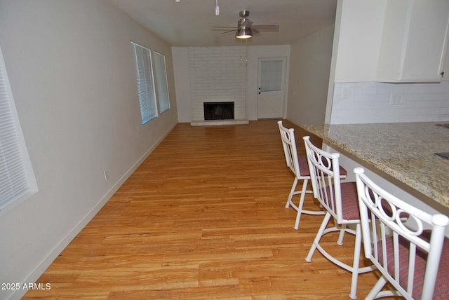 2015 E Southern Ave Unit 23, Tempe, AZ 85282 - living room with light wood-style flooring, a fireplace, and a ceiling fan
