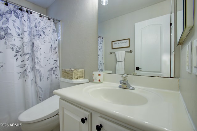 bathroom with vanity, a shower with shower curtain, and toilet