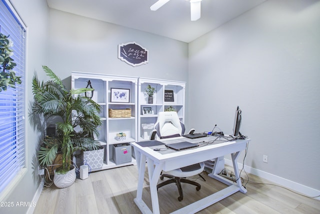 office featuring baseboards, a ceiling fan, and wood finished floors