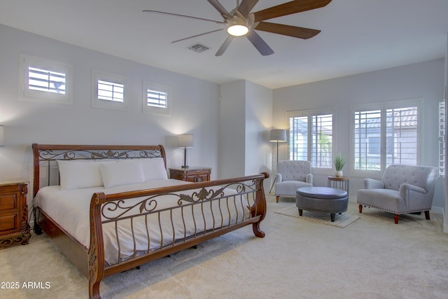 carpeted bedroom with visible vents and a ceiling fan
