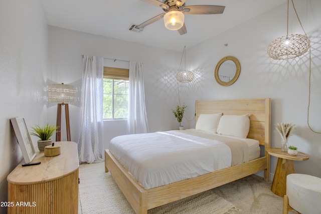 bedroom with visible vents, a ceiling fan, and light colored carpet
