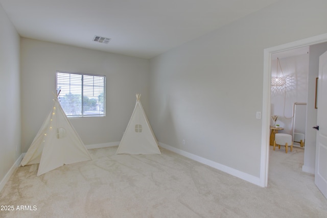 rec room featuring light colored carpet, baseboards, and visible vents