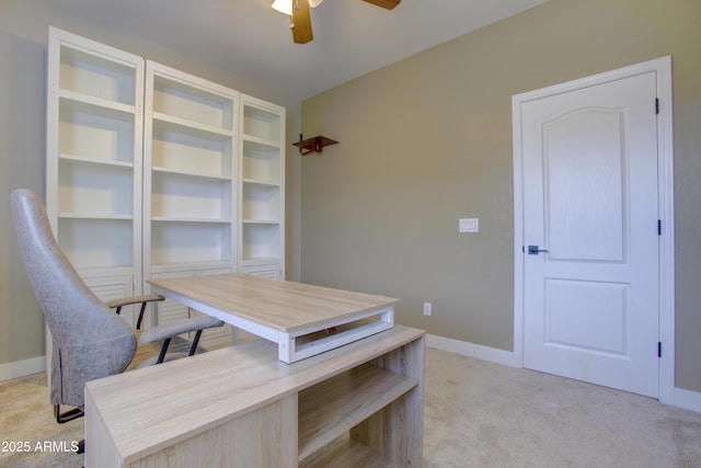 home office featuring light colored carpet, ceiling fan, and baseboards