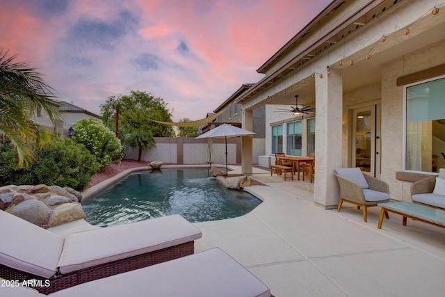 view of swimming pool with a fenced in pool, a fenced backyard, ceiling fan, outdoor dining area, and a patio