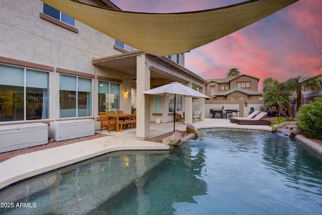 view of swimming pool with a fenced in pool, fence, a ceiling fan, outdoor dining space, and a patio