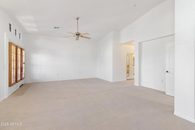 carpeted empty room featuring ceiling fan and vaulted ceiling