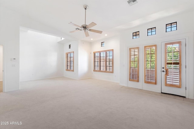 carpeted empty room featuring ceiling fan