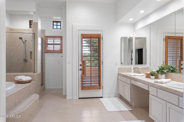 bathroom featuring shower with separate bathtub, tile patterned floors, and vanity