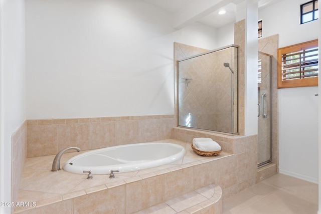 bathroom featuring tile patterned floors and independent shower and bath