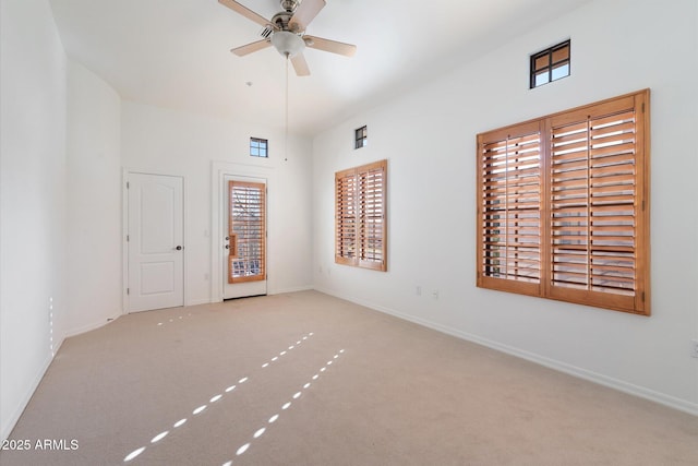 carpeted spare room with ceiling fan and a wealth of natural light