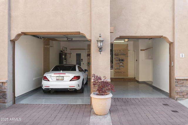 garage featuring water heater and electric panel