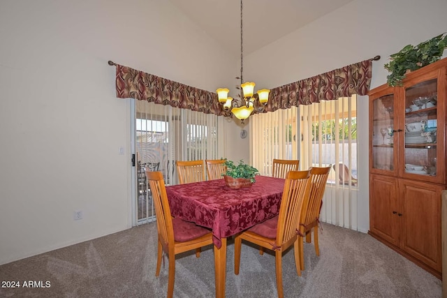 dining area featuring carpet flooring, a chandelier, and lofted ceiling