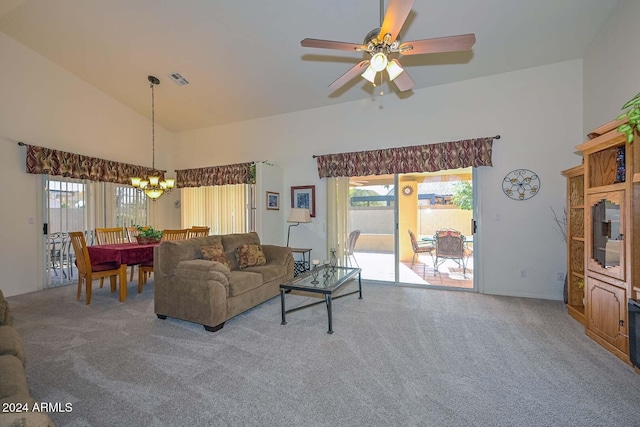 carpeted living room featuring ceiling fan with notable chandelier, high vaulted ceiling, and a wealth of natural light