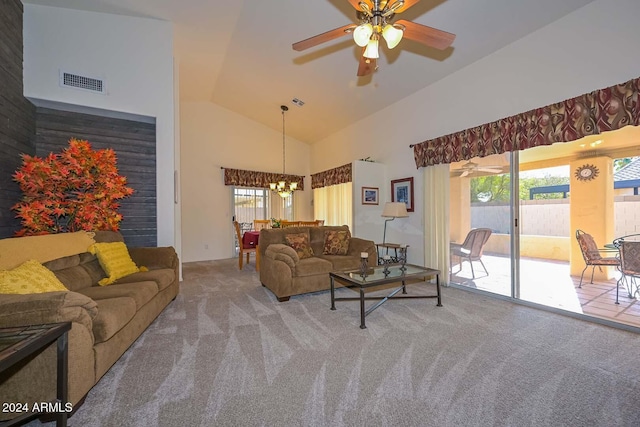 living room featuring ceiling fan with notable chandelier, carpet floors, and high vaulted ceiling