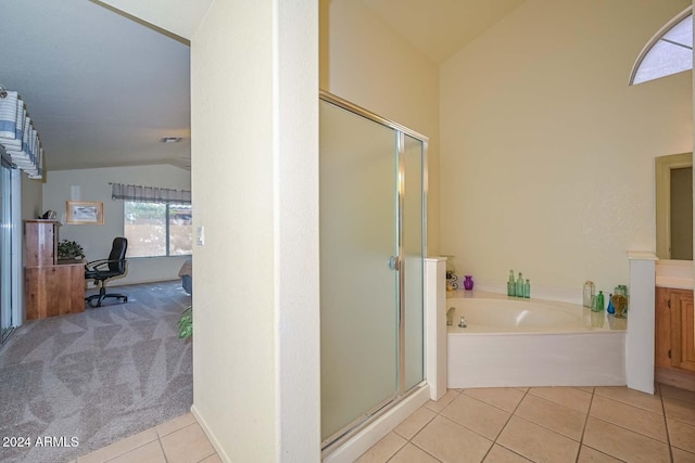 bathroom with tile patterned flooring, separate shower and tub, and lofted ceiling