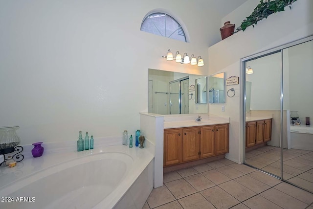 bathroom with plus walk in shower, vanity, and tile patterned floors