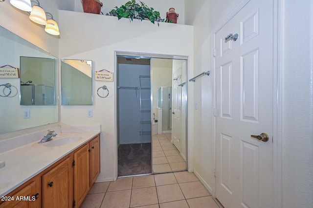 bathroom with tile patterned flooring, vanity, and an enclosed shower