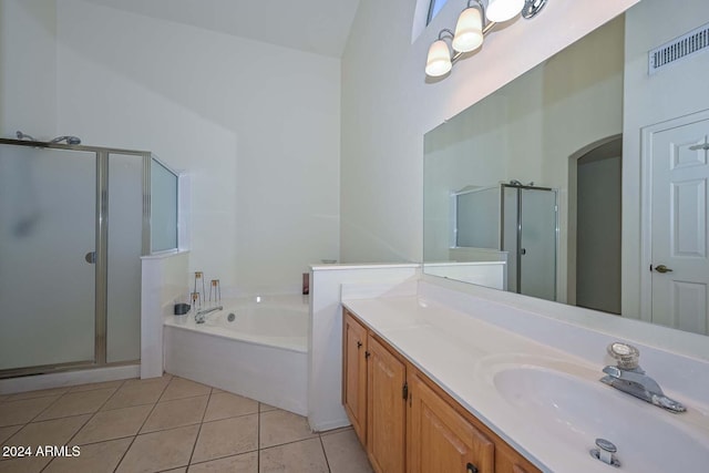 bathroom with tile patterned flooring, shower with separate bathtub, and vanity