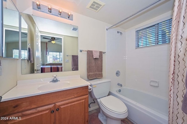 full bathroom featuring shower / bath combination with curtain, vanity, a healthy amount of sunlight, and toilet