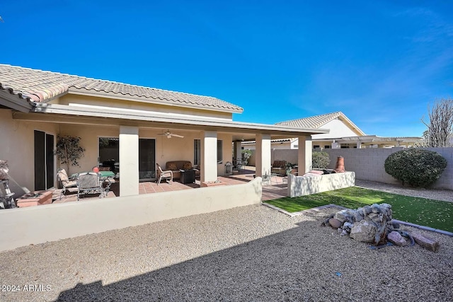 rear view of property featuring a patio area and ceiling fan