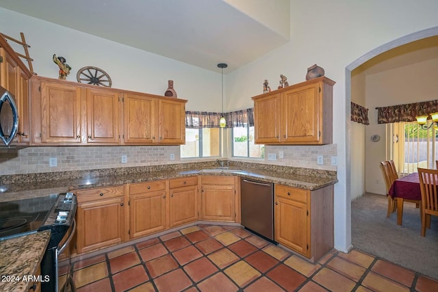 kitchen featuring light carpet, black appliances, sink, hanging light fixtures, and decorative backsplash