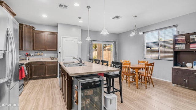 11742 W Chase Ln, Avondale, AZ 85323 - kitchen with a sink, wine cooler, plenty of natural light, stainless steel appliances, and recessed lighting