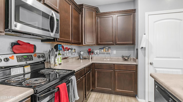 11742 W Chase Ln, Avondale, AZ 85323 - kitchen featuring electric range, stainless steel microwave, dishwashing machine, and light countertops