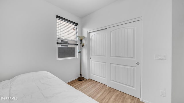 11742 W Chase Ln, Avondale, AZ 85323 - bedroom featuring wood finished floors, a closet, and baseboards