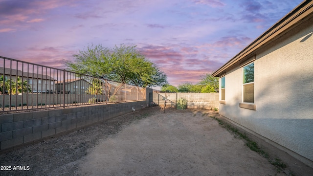 11742 W Chase Ln, Avondale, AZ 85323 - yard at dusk with a fenced backyard and a patio