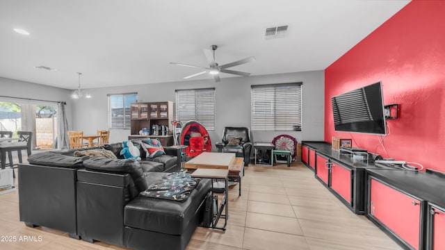 11742 W Chase Ln, Avondale, AZ 85323 - living room featuring light tile patterned floors, a ceiling fan, and a chandelier