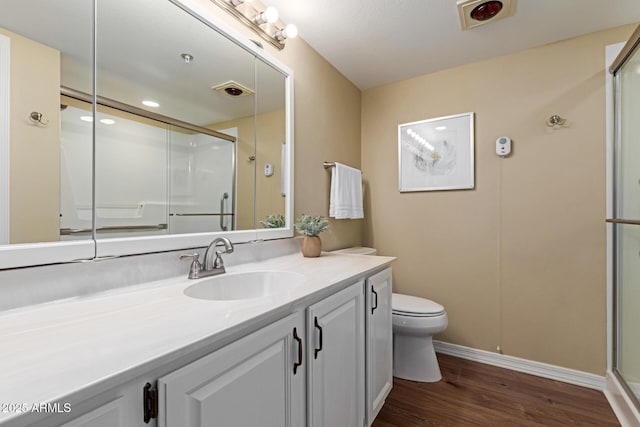 10330 W Thunderbird Blvd Unit A301, Sun City, AZ 85351 - full bathroom with vanity, toilet, a stall shower, wood finished floors, and baseboards