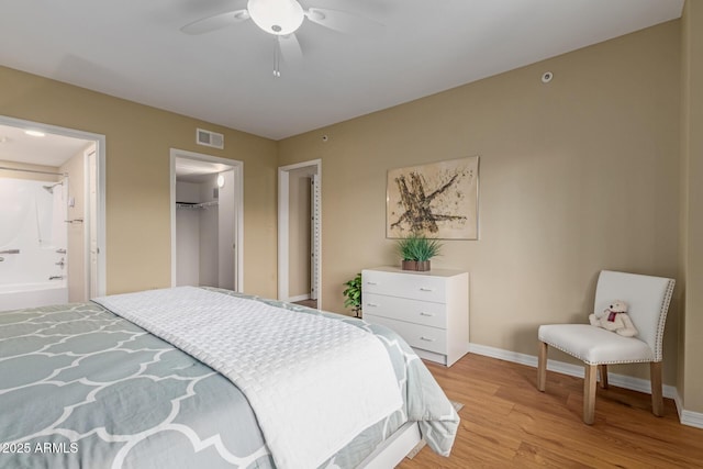 10330 W Thunderbird Blvd Unit A301, Sun City, AZ 85351 - bedroom featuring light wood-style flooring, baseboards, ensuite bath, and a ceiling fan