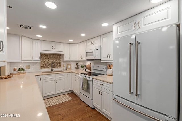 10330 W Thunderbird Blvd Unit A301, Sun City, AZ 85351 - kitchen with white appliances, a sink, white cabinetry, light countertops, and recessed lighting