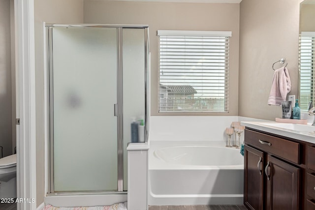 full bathroom featuring toilet, vanity, and shower with separate bathtub