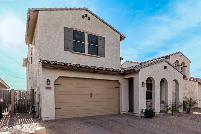 mediterranean / spanish home with a garage