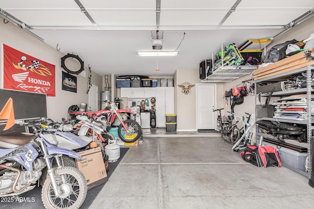 garage featuring water heater and a garage door opener