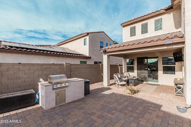 view of patio with a fire pit, an outdoor kitchen, and grilling area