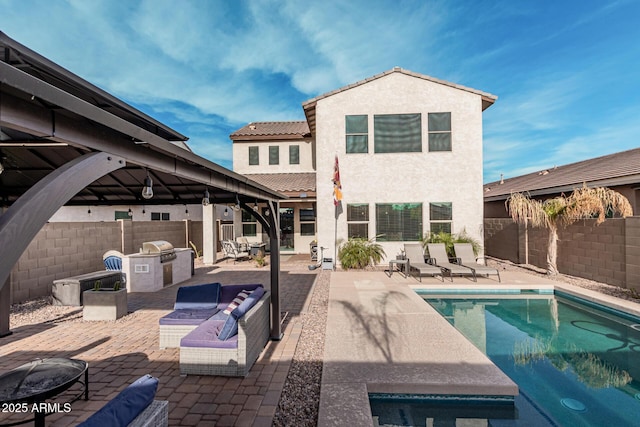 rear view of house featuring a fire pit, a fenced in pool, a patio, area for grilling, and a gazebo