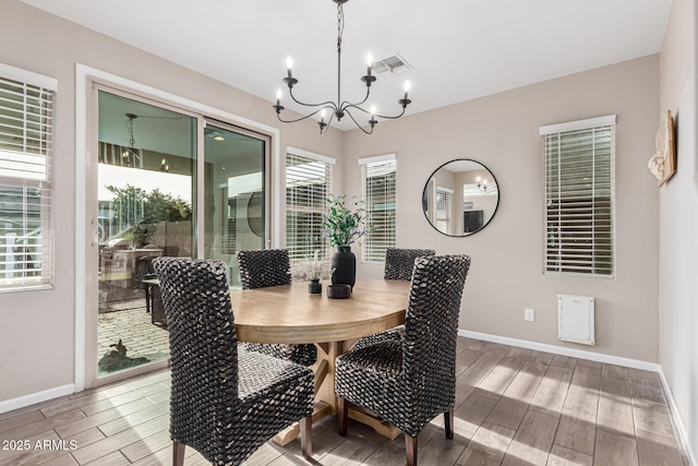 dining area with an inviting chandelier