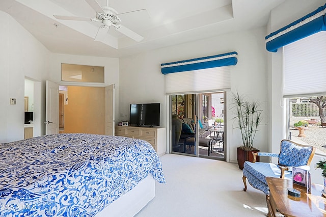 carpeted bedroom featuring access to exterior, multiple windows, and a ceiling fan