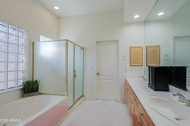 full bathroom with a shower stall, a sink, a bath, and a healthy amount of sunlight