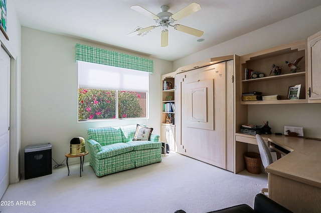 interior space with ceiling fan, carpet flooring, and built in study area