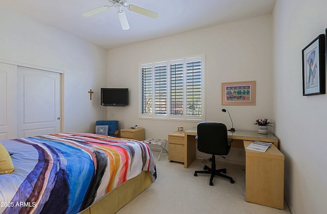 bedroom with a closet, light carpet, and ceiling fan