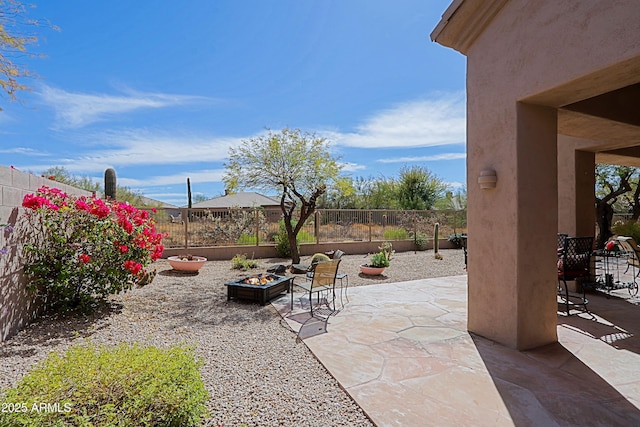 view of patio / terrace featuring an outdoor fire pit and a fenced backyard